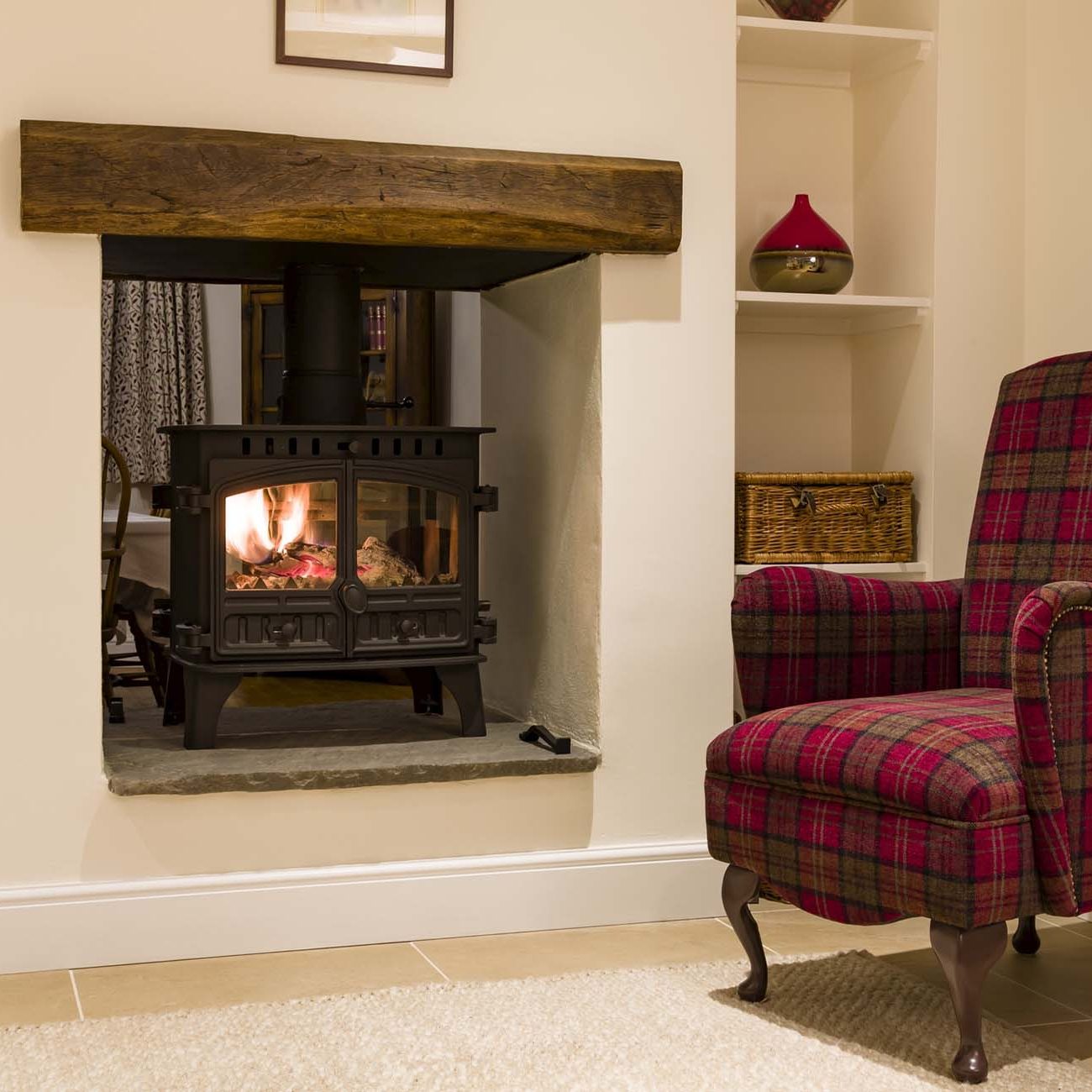 Cosy woodburner and chair in an English home, UK